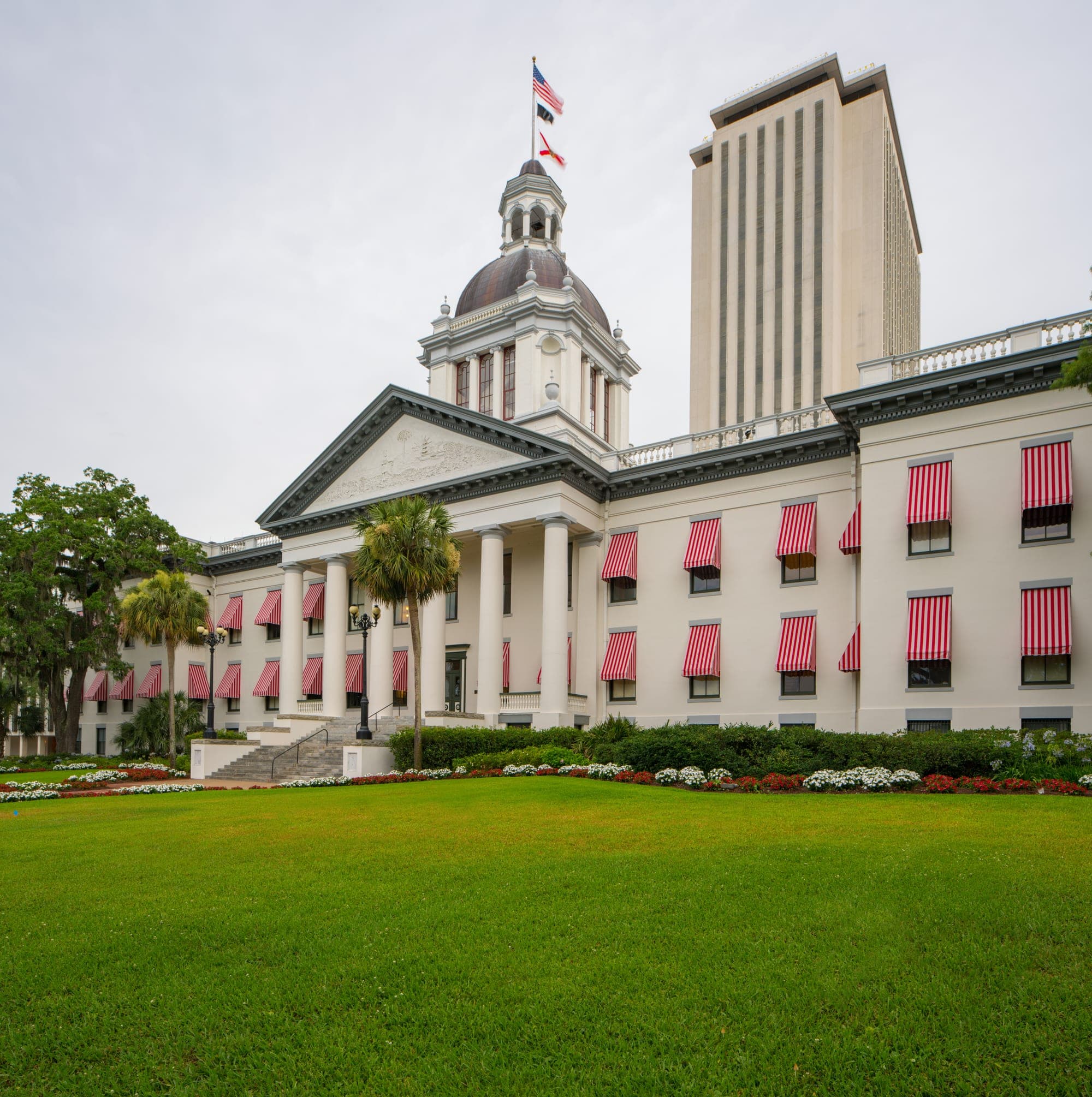 The Florida Historic Capitol with its red-and-white striped awnings, the modern Capitol tower rising behind it.