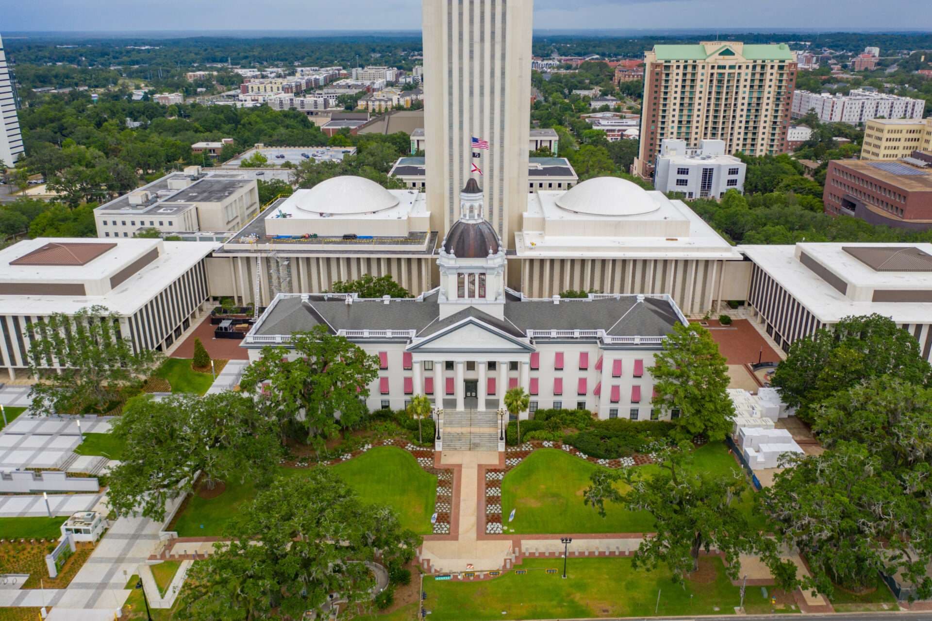 Aerial view of the Florida Capitol complex in Tallahassee, the historic capitol in front of the tower and legislative chambers.